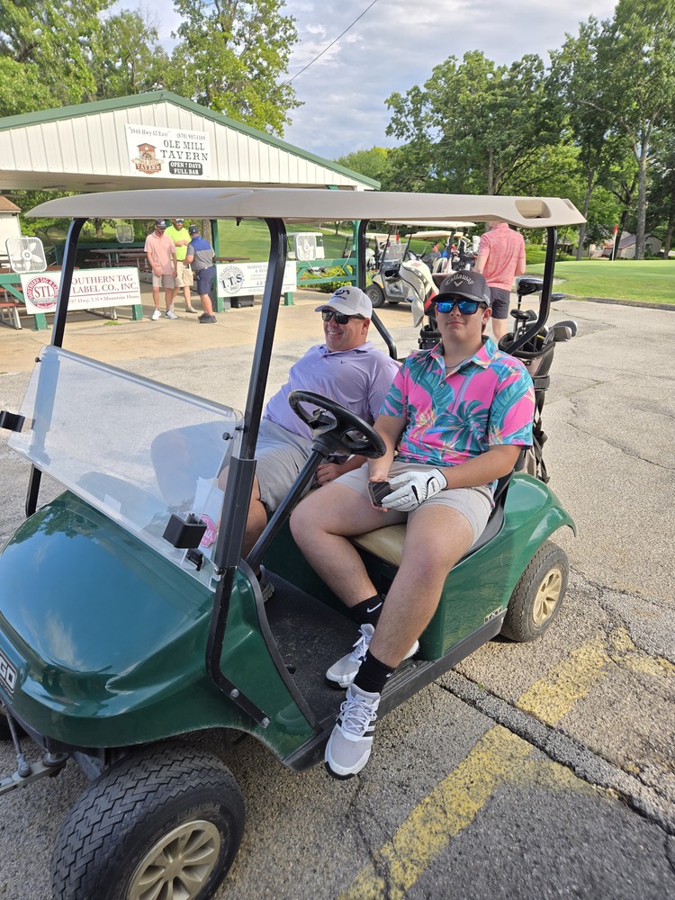 2 guys in a golf cart.